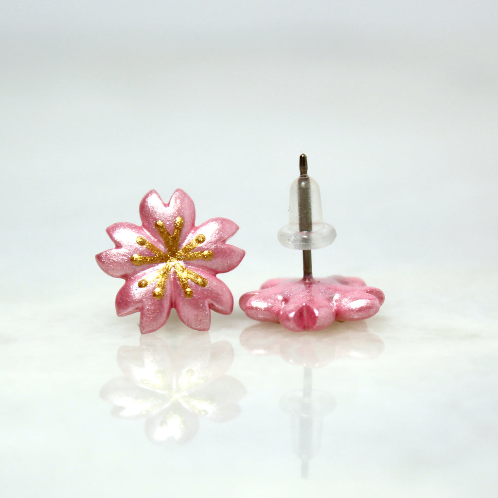 A pair of cherry blossom earrings. The earring posts are 100% hypoallergenic titanium and come with rubber backings.