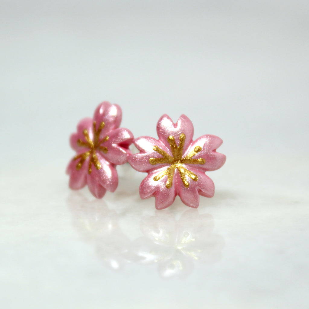 A pair of sparkly cherry blossom earrings.