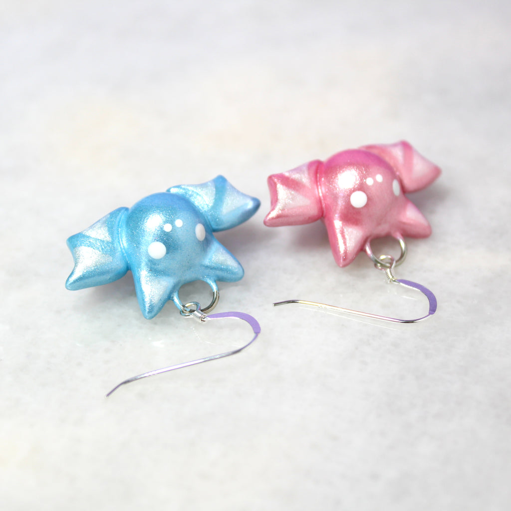 Top view of the mismatched pastel bat earrings. The sterling silver ear wires are .925 grade sterling silver.